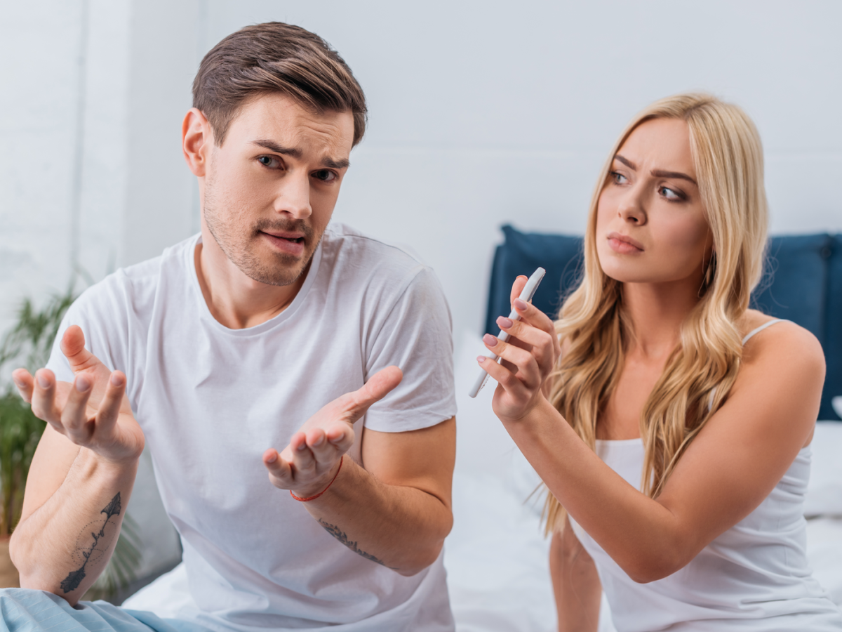 Couple dealing with digital infidelity, where one partner is hurt due to the other's smartphone cheating. Featured in article discussing 'What is Cheating and Infidelity?