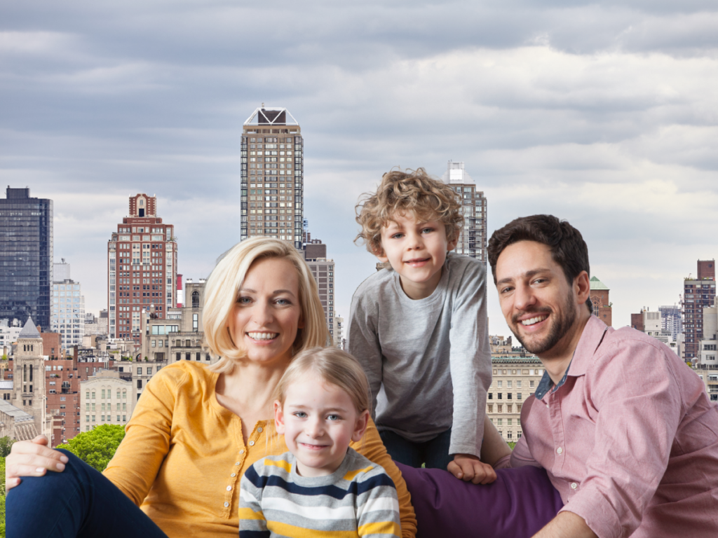 image of happy couple with two children even though husband doesn't want another child