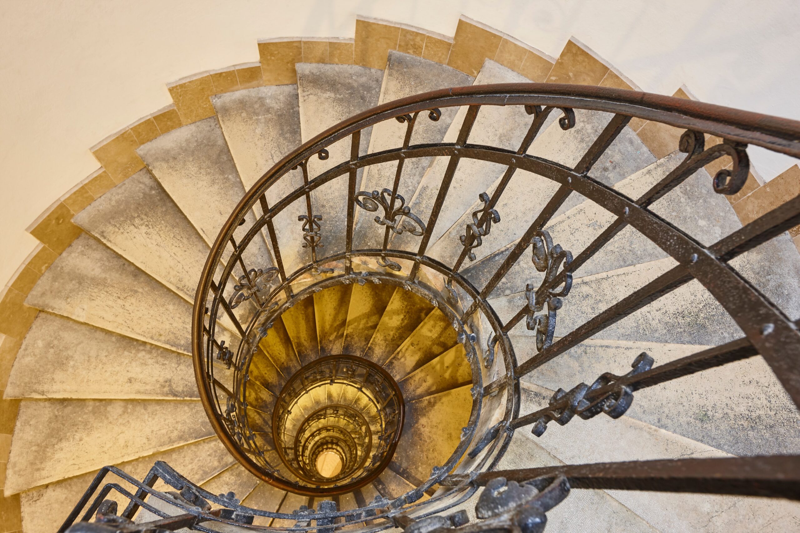  Spiral staircase symbolizing the non-linear journey couples take to heal from infidelity with professional guidance.