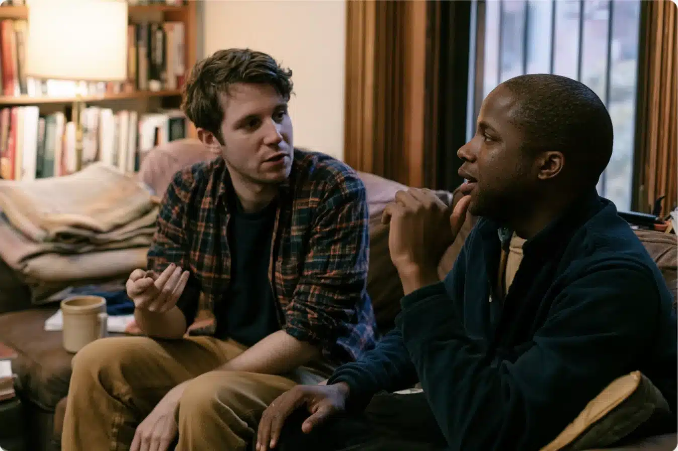 Couple experiencing a quiet moment of disconnection during a difficult conversation at home.