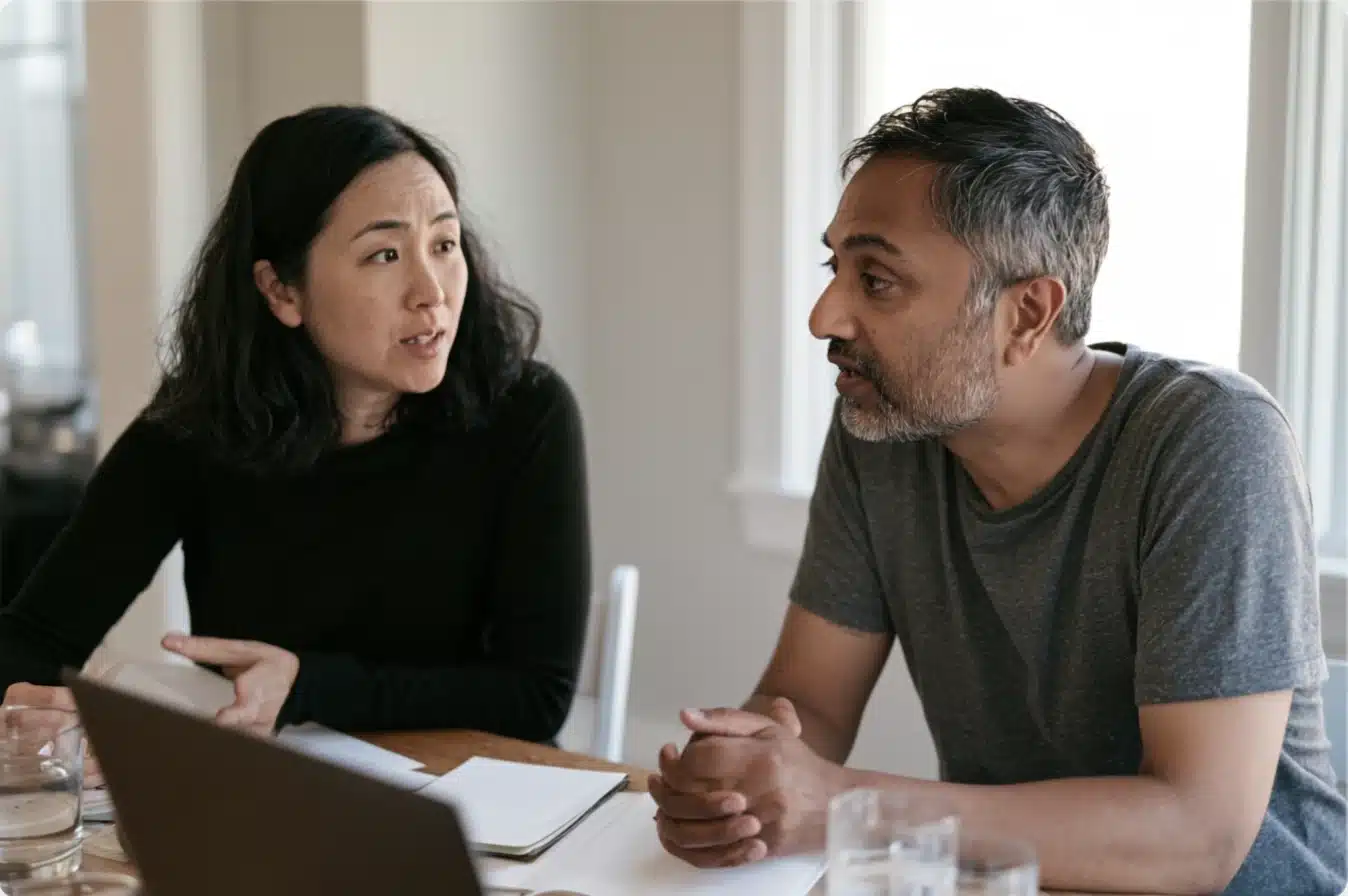 Couple participating together in a private online Gottman Method couples therapy session from home.